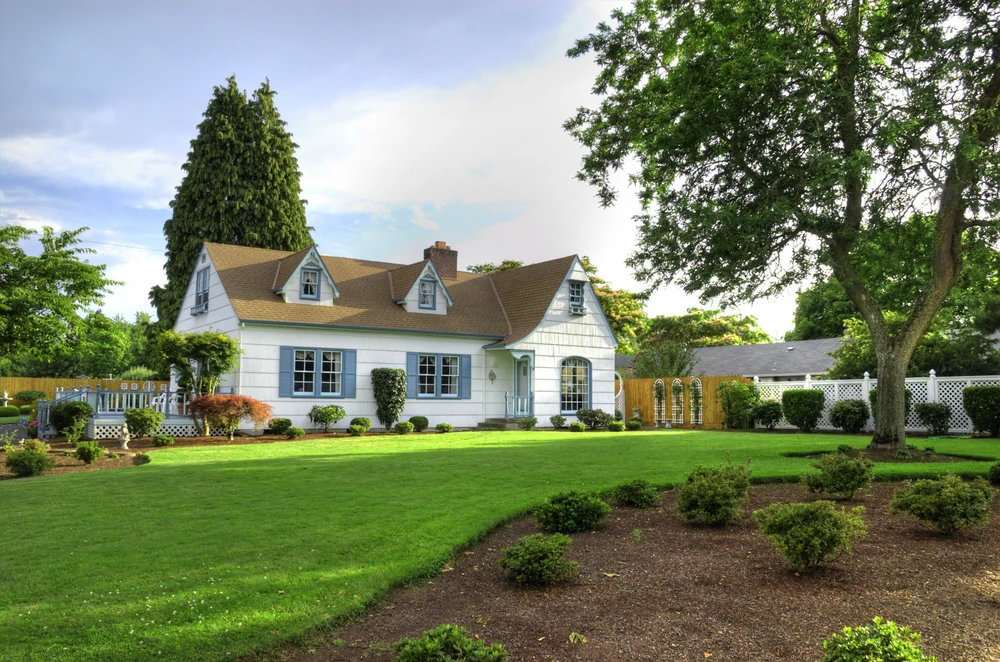 Manicured front yard with trimmed grass and shrubs highlighting professional landscaping ready for spring curb appeal.
