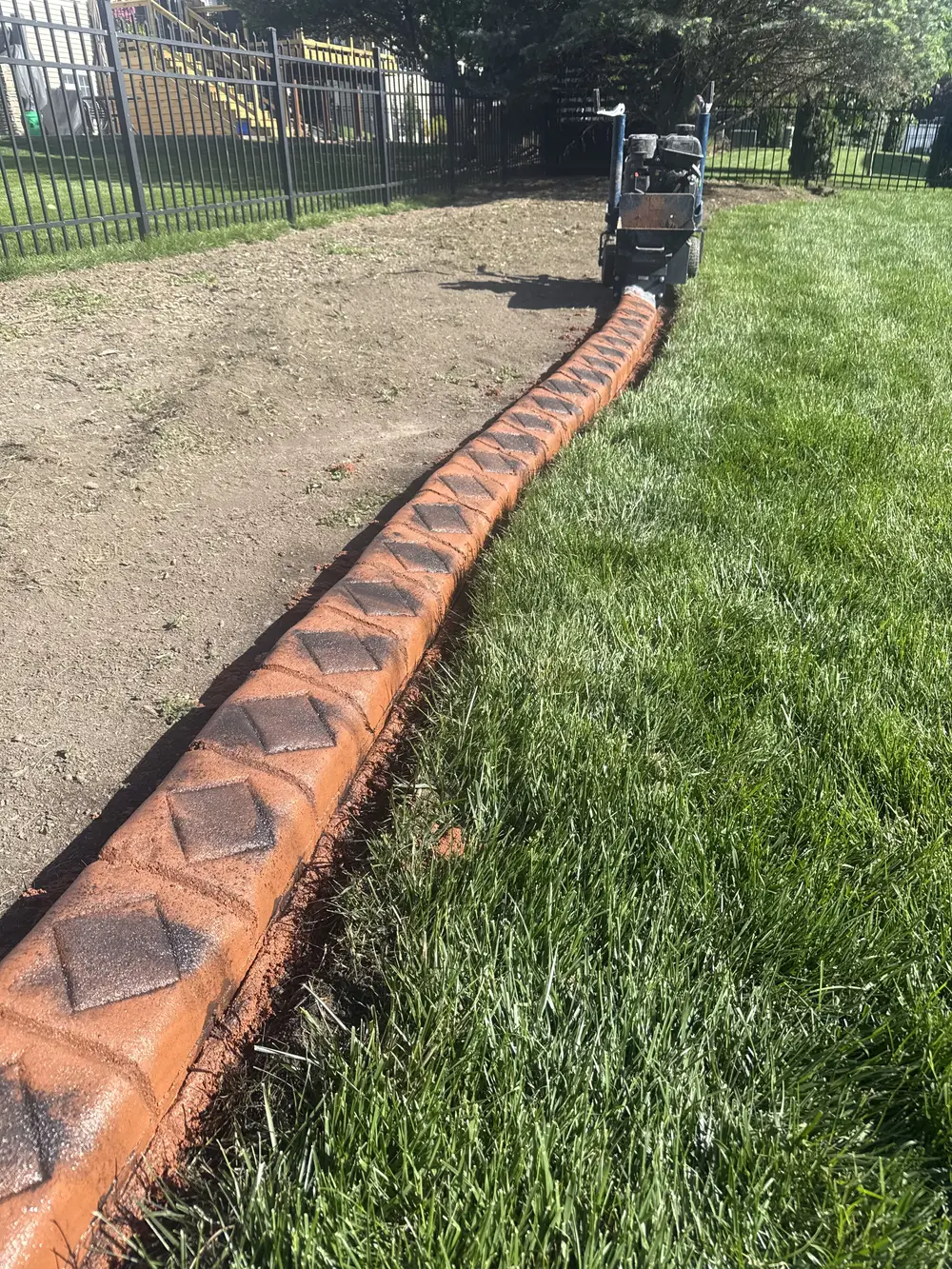 Fresh landscape curbing separates the lawn from a bare bed and lasts longer than basic edging.